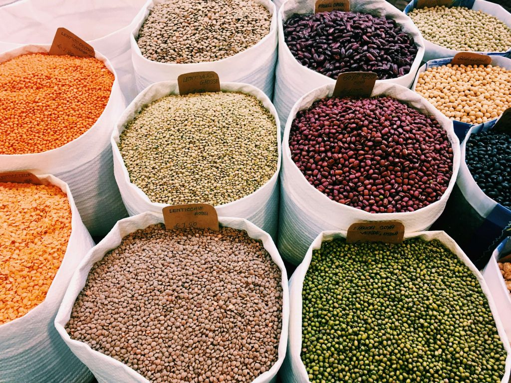 canvas bags filled with various beans and legumes