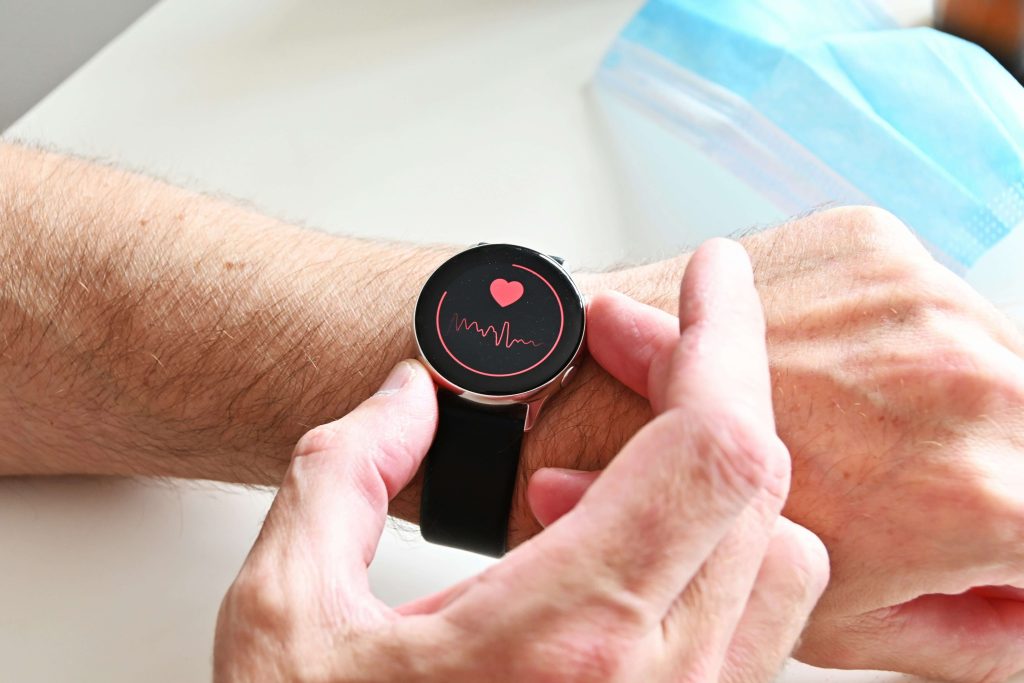 man checking his pulse using a smart watch to monitor his heart health.